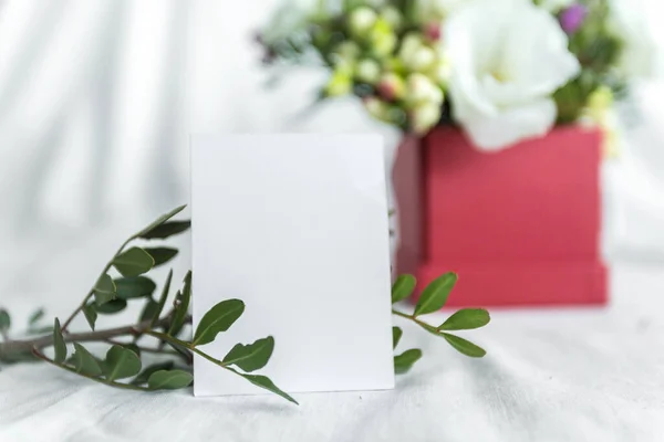 Postcard with a flowers and an empty tag for text. Romantic greeting and surprise. Concept of love, birthday, Happy mother's Day and Valentine's Day on white background. Selective focus. copy space