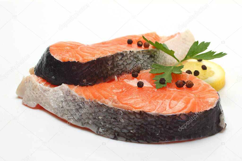 salmon fillet with lemon and rosemary on white background