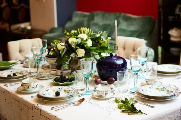 Красиво прикрашений набір столу з квітами, свічками, тарілками і серветками для весілля або іншої події в ресторані . — стокове фото