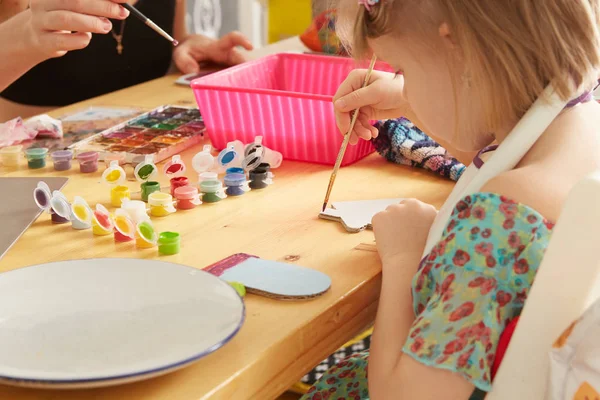 Schattig klein meisje schilderen op home interieur achtergrond — Stockfoto