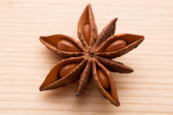 Organic star anise on a wooden table — Stock Photo, Image