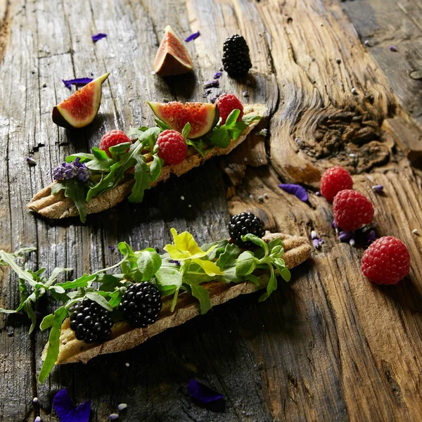 Three portions of homemade dessert fresh berries on a wooden background — Stock Photo, Image