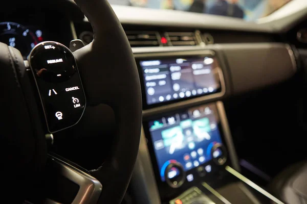 Modern car interior. Shallow DOF. Steering wheel in focus — Stock Photo, Image