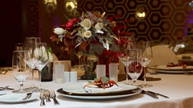 Çatal, bıçak, tabak ve camlı masa ayarları.