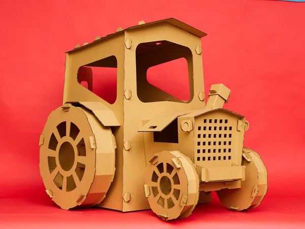 The cardboard tractor on red background. Agricultural and eco concept — Stock Photo, Image
