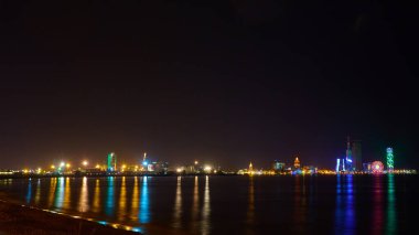 Adjara 'nın başkenti Batumi' deki Karadeniz limanındaki ışıkların gece yansımaları. Georgia.