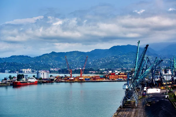 Batumi, Georgia - June 09, 2015: Batumi International Container Terminal. Cargo port in Batumi, Georgia. Cargo port with blue sea and blue sky, ships, trains cranes, containers — Stock Photo, Image