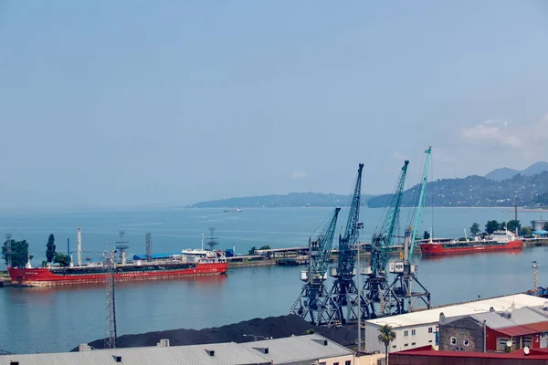 Batumi, Georgia - June 09, 2015: Batumi International Container Terminal. Cargo port in Batumi, Georgia. Cargo port with blue sea and blue sky, ships, trains cranes, containers — Stock Photo, Image