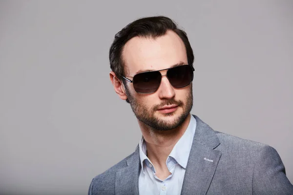 Studio portrait of handsome elegant young man in grey jacket — Stock Photo, Image