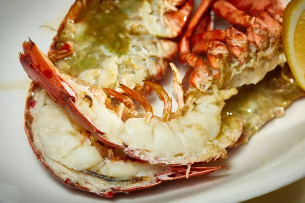 A luxury dish of lobster roasted and decorated with lemon and basil. Shallow dof — Stock Photo, Image