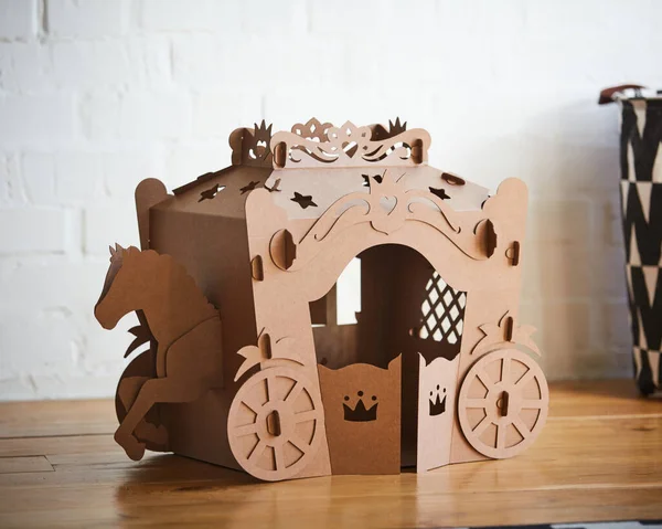 A horse and a carriage made of brown cardboard,where the horse is pulling the carriage. — Stock Photo, Image