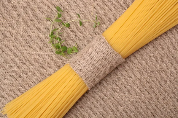 Close up of spaghetti and oregano on fabric — Stock Photo, Image