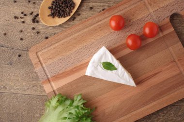Brie peyniri ve domates ahşap arka plan üzerinde