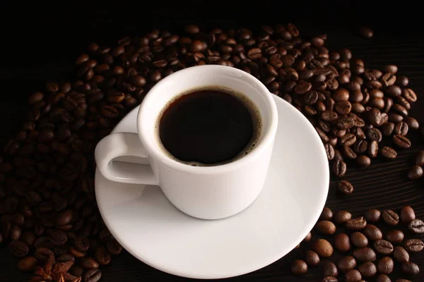 White glass of coffee and coffee beans