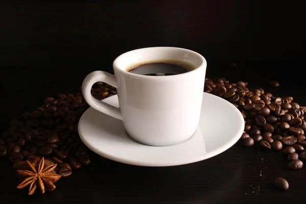 White glass of coffee and coffee beans