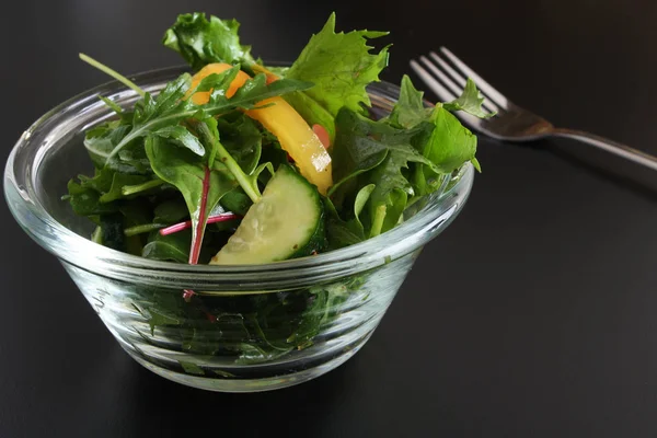 Vegetable salad on a black background — Stock Photo, Image