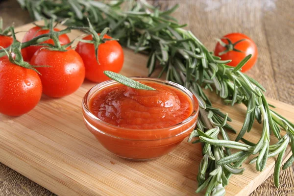 Tomato sauce ketchup tomatoes rosemary — Stock Photo, Image