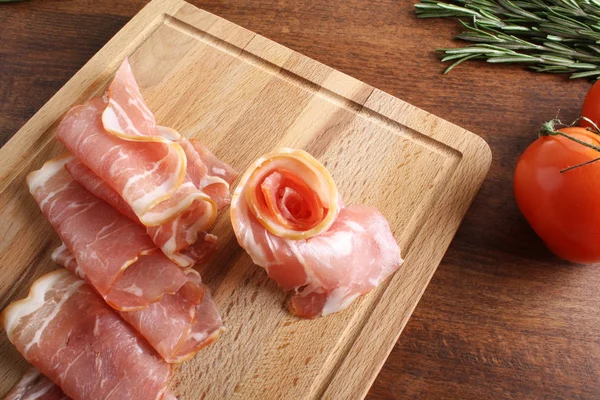 Bacon sliced on a wooden background — Stock Photo, Image