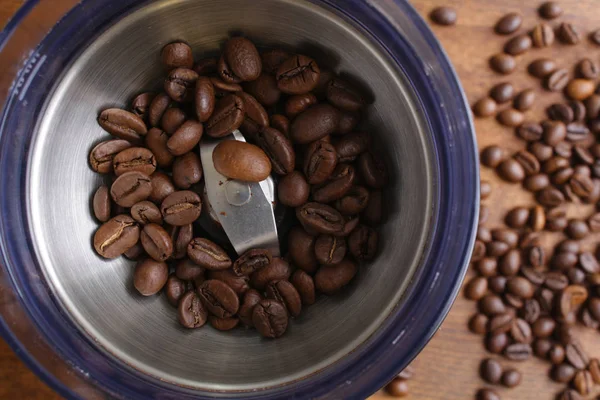 Coffee beans in an electric coffee grinder — Stock Photo, Image