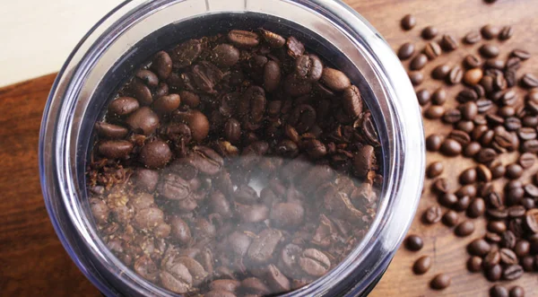 Coffee beans in an electric coffee grinder — Stock Photo, Image