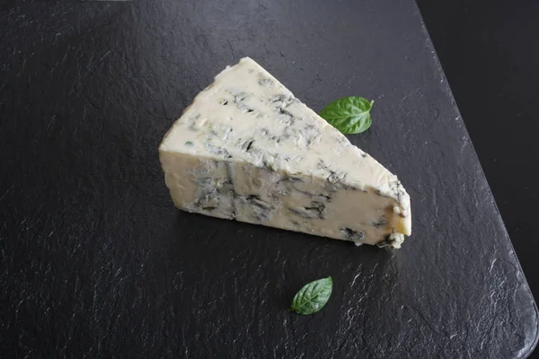 黒い石の背景にブルー チーズ — ストック写真
