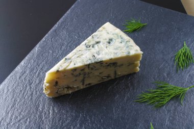 karanlık bir taş zemin üzerine mavi peynir