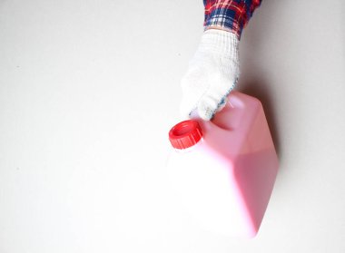 Işık arkaplan üzerinde eldivenli pembe tüp.