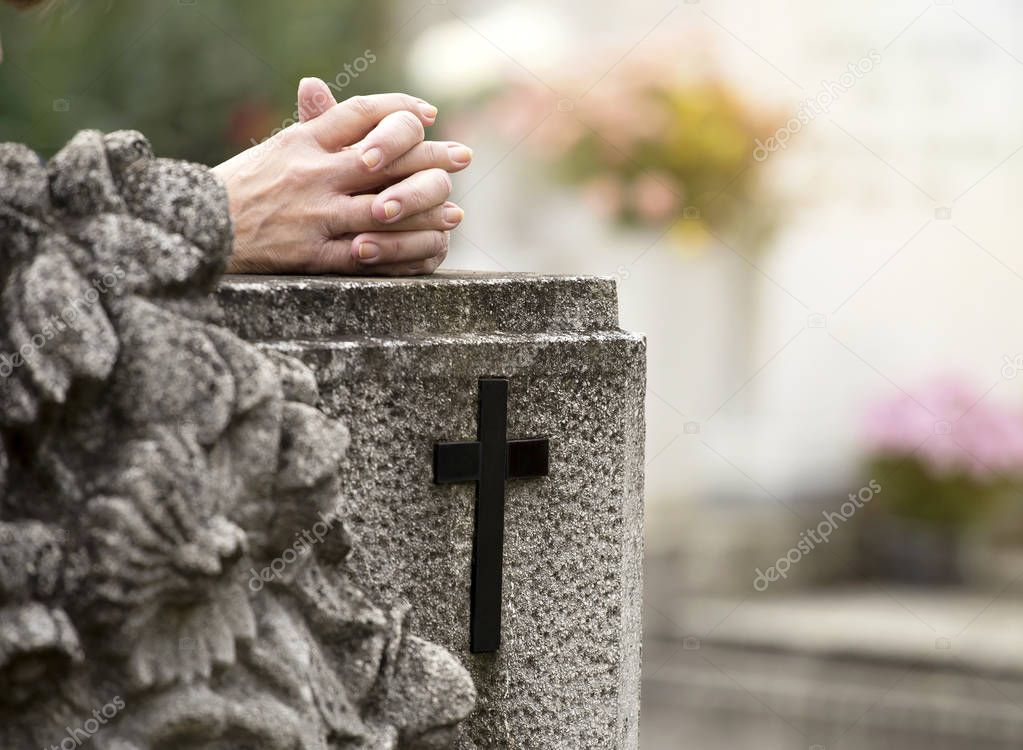 Praying in cemetery