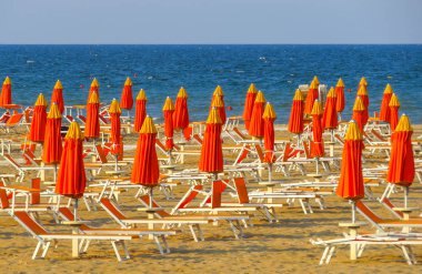 Rimini - Orange umbrellas and sunbeds clipart