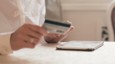 Kadın camdan tabletle online alışveriş yapıyor.
