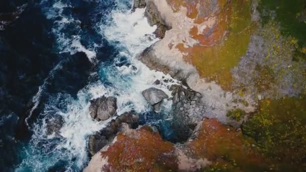 在令人难以置信的岩石海岸上空飞行的无人驾驶飞机蓝色的波浪在阳光灿烂的大滨海景色下坠毁在悬崖上 — 图库视频影像