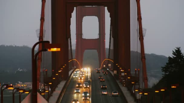 日没後のサンフランシスコの象徴的なゴールデンゲートブリッジの夜遅くの車の信号の美しい景色 — ストック動画