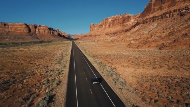 Drone Camera Follows Silver Car Moving Straight Desert Highway Road — Stock Video