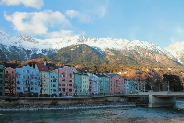 Street of multi-colored houses at foot of mountains. Innsbruck, Austria — Stock Photo, Image