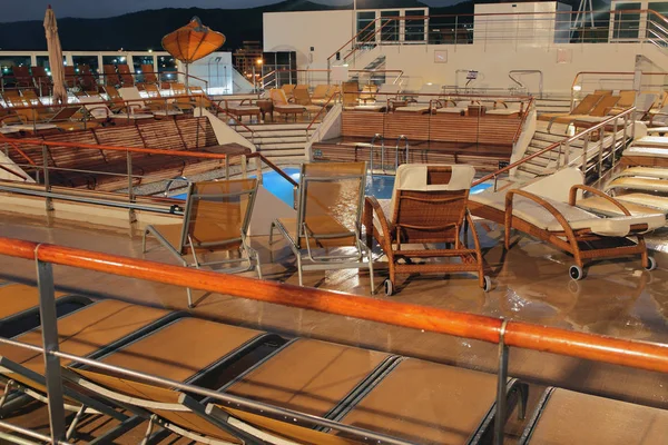 Recreation area at pool on cruise liner in evening — Stock Photo, Image