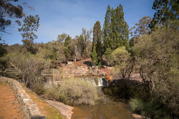 A pedestrian bridge over the water falls and river in John Forrest National Park — Stock Photo, Image