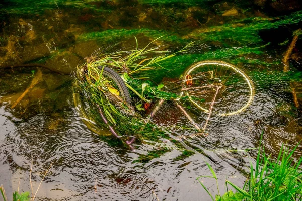 A sunken bicycle in shallow waters of river Don in Seaton park,