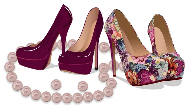 Pair of eleg��ant high heeled shoes and pearl beads isolated