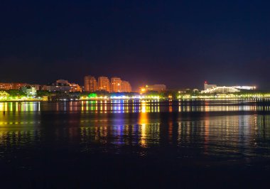 A quiet, warm southern city, on the beach, in the night city lights. A great place to relax.