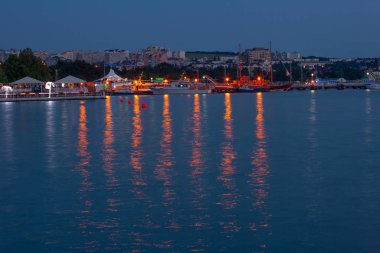 A quiet, warm southern city, on the beach, in the night city lights. A great place to relax.