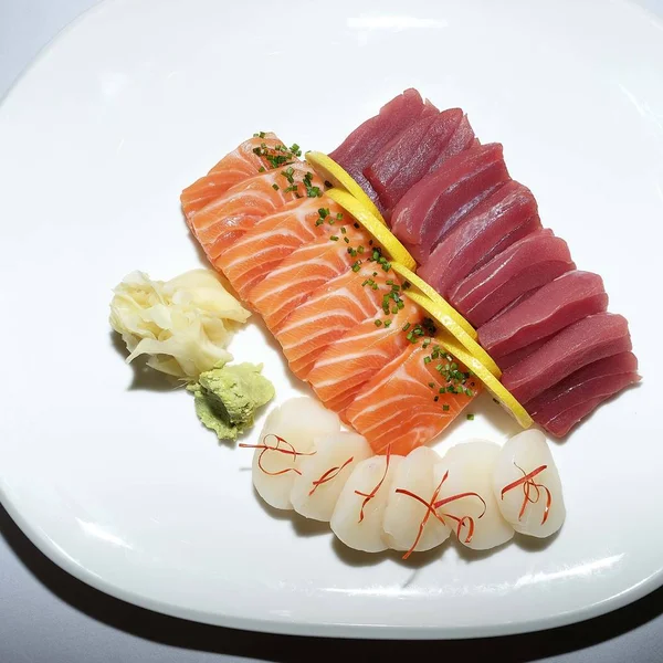 Delicious fresh sushi laid out on a plate in bright light. Japanese food. large set of sushi pieces beautifully laid out on a plate and isolated on white