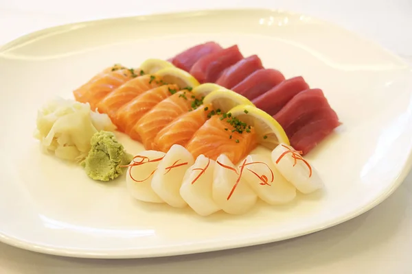 Delicious fresh sushi laid out on a plate in bright light. Japanese food. large set of sushi pieces beautifully laid out on a plate and isolated on white