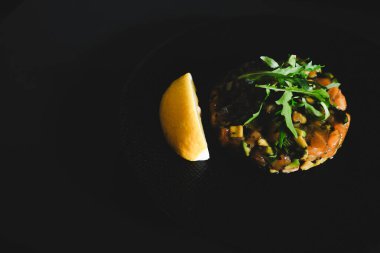 Somon tartare taze çiğ somon balığı, avokado ve limon dilimi ile yapılır. Bu sağlıklı yemek genellikle güzel restoranlarda aperatif olarak sunulur..