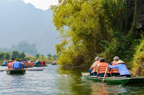 International tourists traveling on local vietnamese small boat