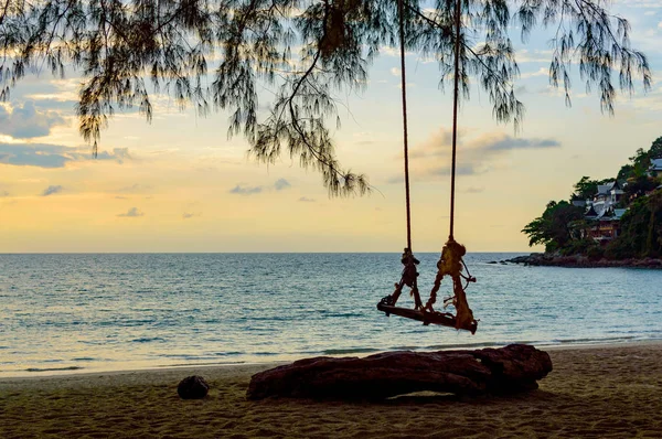 Swings at tree on the sand tropical beach