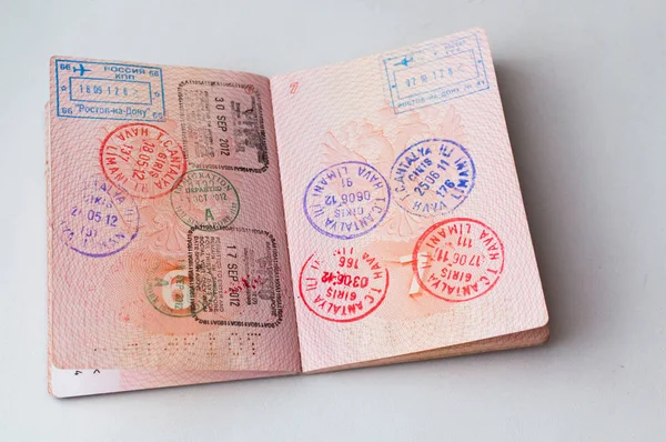 Russian passport stamped on border crossing. Departure and arrival immigration stamps. — Stock Photo, Image
