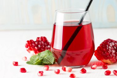 Bir bardak nar suyu ve ahşap masada taze nar meyveleri. Vitamin ve mineraller. Sağlıklı içki konsepti.