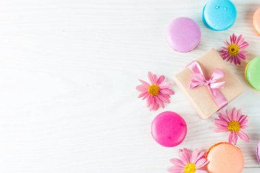 Pasta macarons, hediye kutusu, çay, kahve, cappuccino ve çiçek fotoğrafı. Tatlı romantik gıda acıbadem kurabiyesi kavramı. Sabah kahvaltı ve hediyeler. Sevgililer günü kavramı.