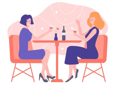 Couple of girls sitting at a table in a restaurant