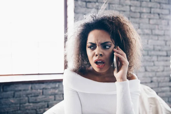 Angry sad girl  african american talking on phone with expensive